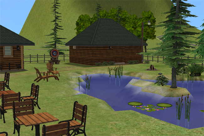 A Sims 2 park pond with benches, reeds, lily pads, target practice, trees, and cabin-style buildings nearby.