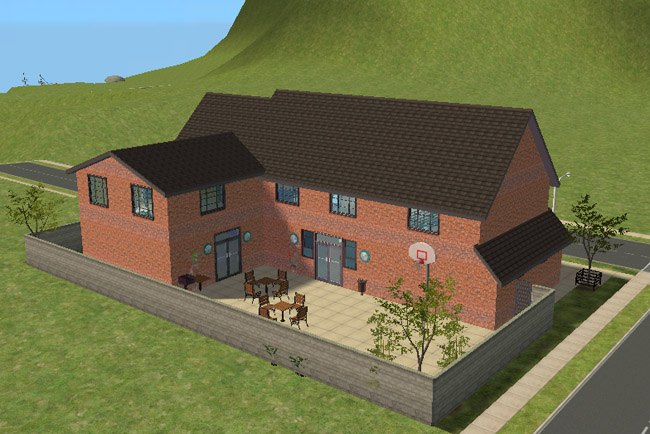 A rear view shows the brick community center with a walled patio, outdoor tables and chairs, a basketball hoop, trees, double doors, and surrounding sidewalks.