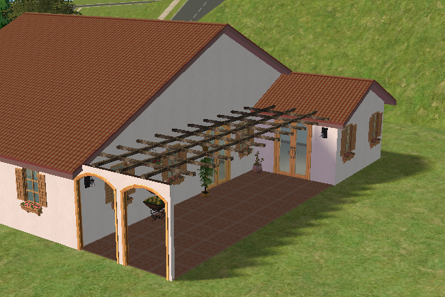 Back patio view of Villa Luisa showing a covered pergola-style outdoor area, arched openings, patio seating space, rear doors, and warm Mediterranean exterior details.
