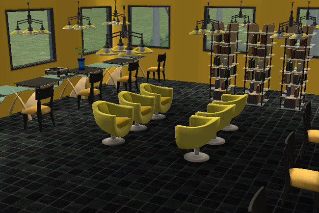 Interior media center view of Newbie Hall featuring rows of desks, computers, bookshelves, yellow chairs, dark flooring, large windows, and seating for student study or computer use.