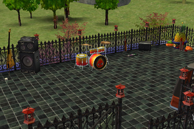 Rooftop patio view of Winter Green Restaurant showing a live band setup with drums, guitar, speakers, seating, decorative lanterns, and wrought-iron fencing around the upper terrace.