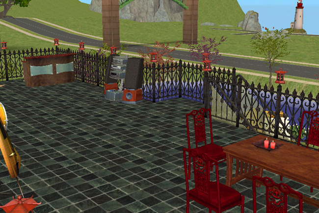 Rooftop patio view of Winter Green Restaurant showing outdoor dining tables, stereo equipment, wrought-iron fencing, red lanterns, and scenic views across the water.