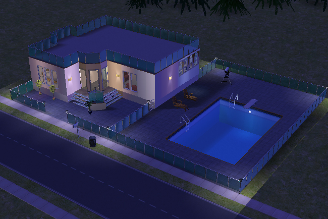 Nighttime exterior view of the Chianti house illuminated with soft lighting around the expansive patio and large outdoor swimming pool.