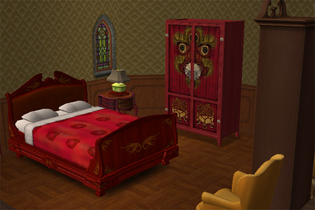 A red bedroom with a carved double bed, patterned walls, stained-glass window, painted wardrobe, armchairs, and warm wood flooring.