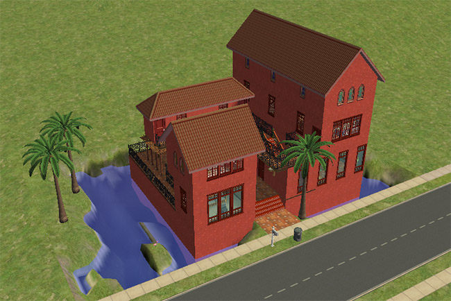 An angled front view of the tall red home with palm trees, large windows, raised outdoor stairways, and water around the lot.