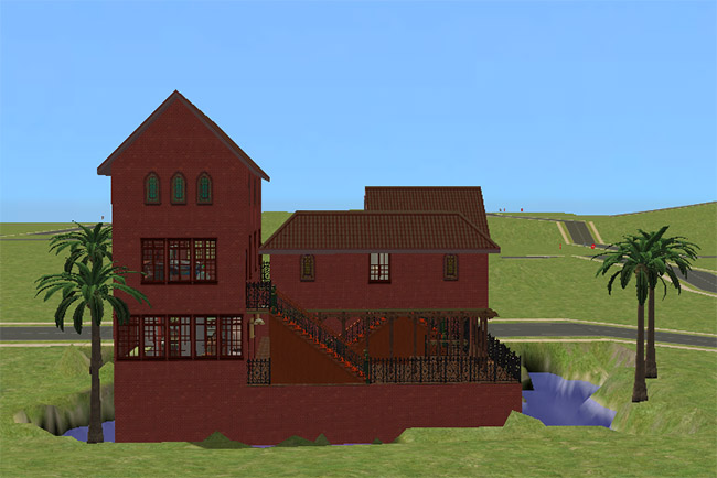 The rear of the tall red home with stacked windows, raised terraces, exterior stairs, black railings, palm trees, and water below.