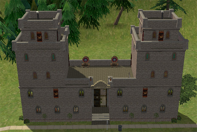 A tall stone castle with twin towers, battlements, arched windows, front steps, and a narrow central entrance on a small lot.