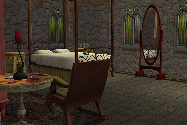 A bedroom with an ornate canopy bed, draped fabric, a pink wardrobe, patterned rugs, candle stands, a small sitting area, and dark tiled flooring.