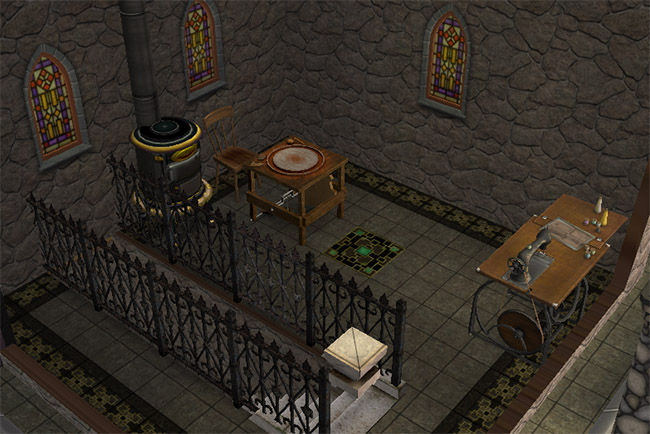 A small tower room with a sewing table, pottery wheel, fireplace, gothic windows, railing, and dark tiled flooring.