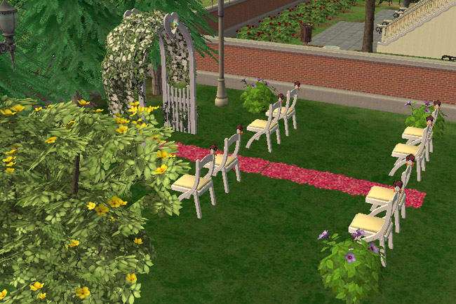An outdoor wedding area sits among trees and flowers, with rows of chairs, a decorated wedding arch, garden paths, and the hotel grounds nearby.