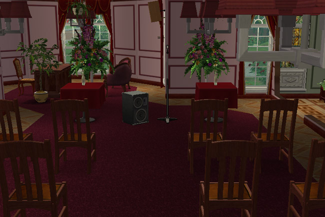 A formal conference area includes dining tables, chairs, plants, a desk, a computer, tall windows, and dark red walls.