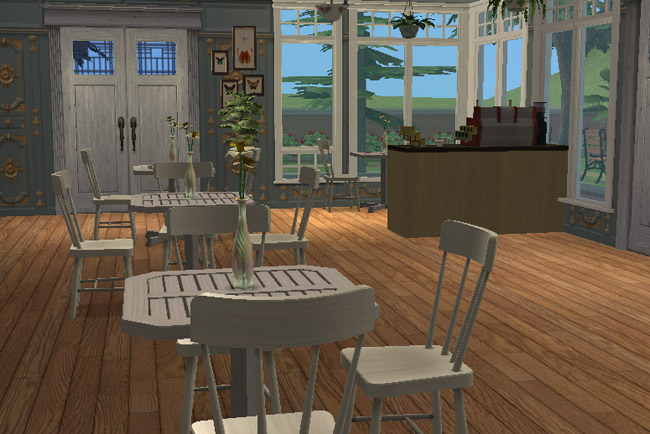 A ground-floor cafe includes round tables, white chairs, tall windows, a host or service station, warm wood flooring, and a view toward the grounds.