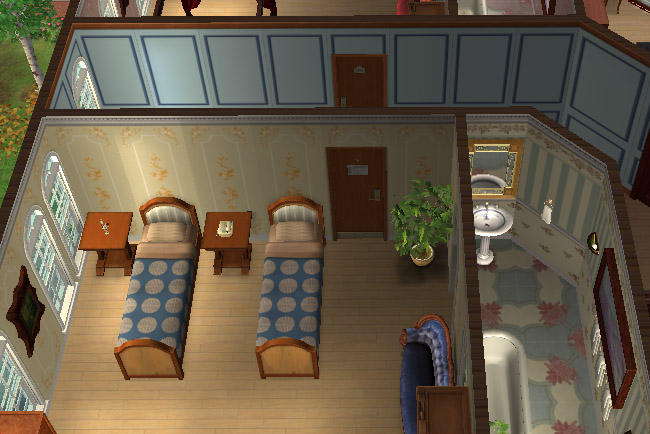 A twin suite has two single beds, blue bedding, a bathroom area, bedside tables, arched windows, and warm wood flooring.
