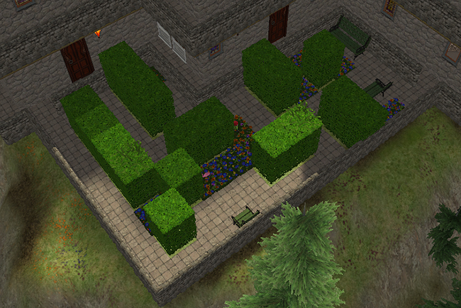Exterior hedge garden courtyard at Greystoke featuring geometric trimmed hedges, stone walkways, flowerbeds, benches, and enclosed castle-like stone walls.