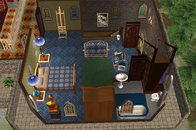 East wing bedroom suite in Greystoke showing blue-themed décor, private bathroom fixtures, stained glass windows, seating area, and ornate gothic furnishings.