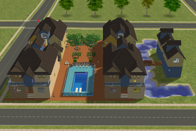 Front exterior view of Lake Haven Townhomes showing the dormitory-style townhome buildings, central pool courtyard, connecting walkways, nearby pond, and shared outdoor gathering areas.