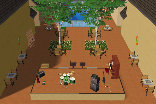 Outdoor courtyard view of Lake Haven Townhomes showing café tables, shaded trees, a raised music stage with instruments, pool access, and shared gathering space between the buildings.