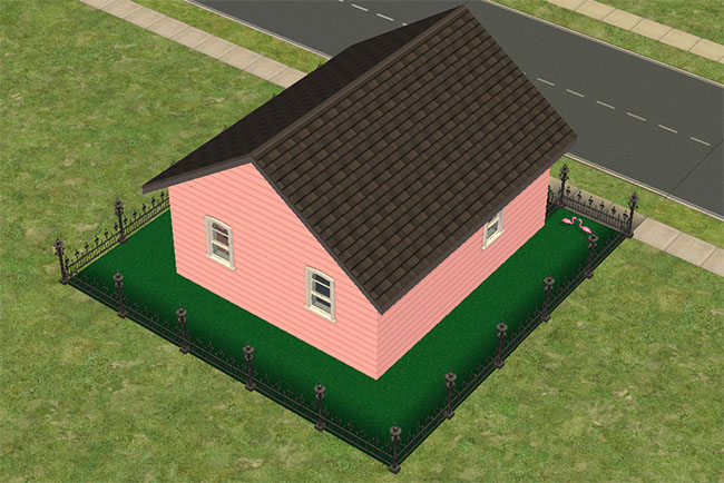 An angled rear view shows the small pink house enclosed by a black iron fence, with green astroturf covering the yard and simple windows set into the back and side walls.