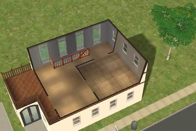 Cutaway second floor view showing a large bedroom area, open loft space, staircase access, and balcony deck suitable for outdoor seating or relaxation.