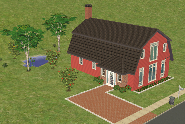 Front exterior view of Barn Conversion, a red barn-style home converted into a residential property with dark roofing, tall front windows, brick driveway, flowerbeds, and a small pond nearby.