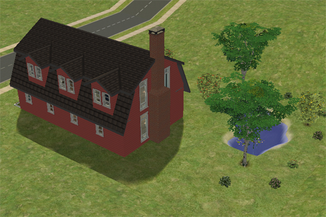 Rear exterior view of Barn Conversion 1 showing the red barn siding, dark roofline, dormer windows, tall brick chimney, pond, trees, and surrounding open yard.