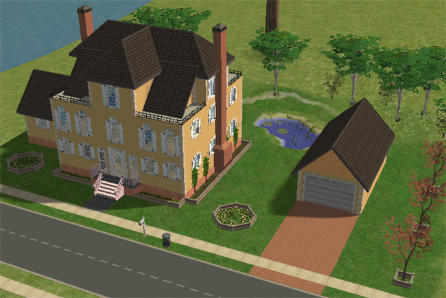 An angled exterior view of a large yellow Sims 2 chateau with a detached garage, brick driveway, pond, garden beds, and layered rooflines.