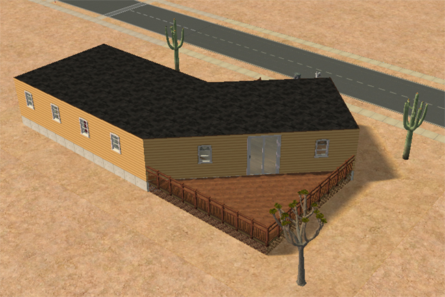 The rear of a yellow desert home with a large wooden deck, railing, back stairs, pale windows, sliding doors, cactus plants, and sandy terrain.