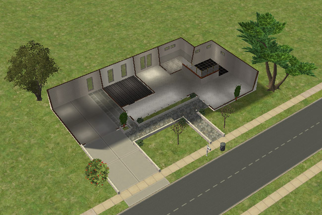 An overhead floor plan of an unfurnished one-bedroom home with one bathroom, garage, driveway, open living space, kitchen area, and glass-covered front entry.
