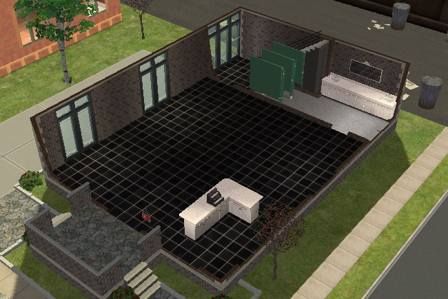 A cutaway view of the first floor shows an open black-tiled space with shop fixtures, a counter area, dressing rooms, and a bathroom.