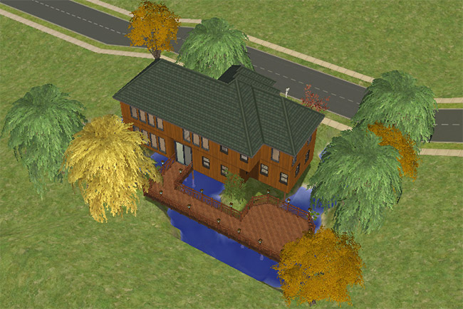 A rear view shows the large wooden deck wrapping around the house beside blue water and autumn-colored trees.